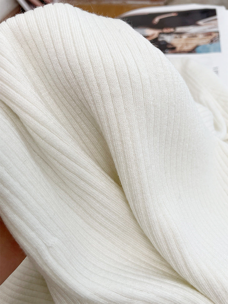 French knitted dress with a socialite style slit and five quarter sleeves, paired with a base skirt